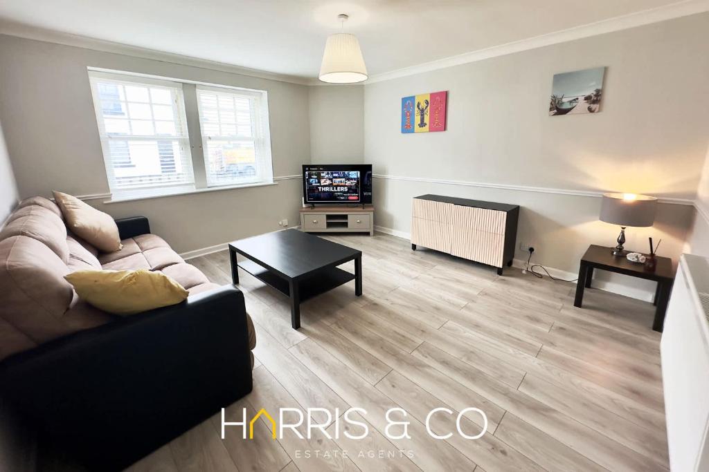 a living room with a couch and a tv at Crews Cabin in Fleetwood