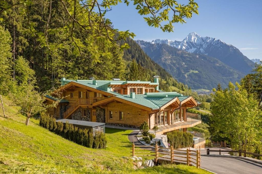 a large wooden house with a green roof at Chalet Residenz Mühlermoos - Terrassen Chalet in Ramsberg