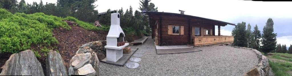 a small wooden cabin on a hill with aitating at Chalet Hochzillertal in Mühlfeld