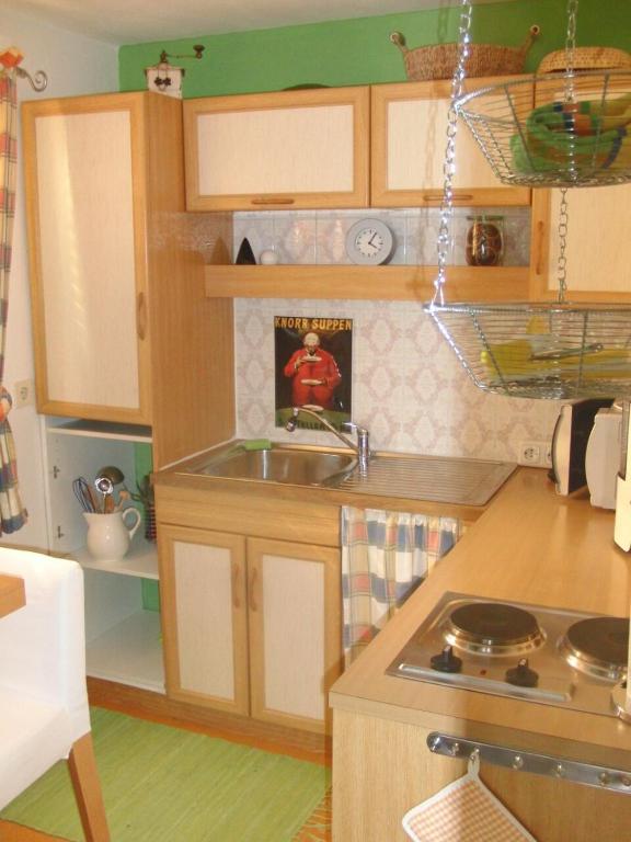 a small kitchen with a sink and a stove at Ferienwohnung Anne in Sankt Ulrich am Pillersee