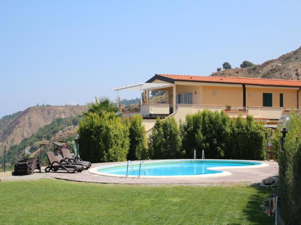 a house with a swimming pool in a yard at Family Sea-View Retreat in Parghelia in Parghelia