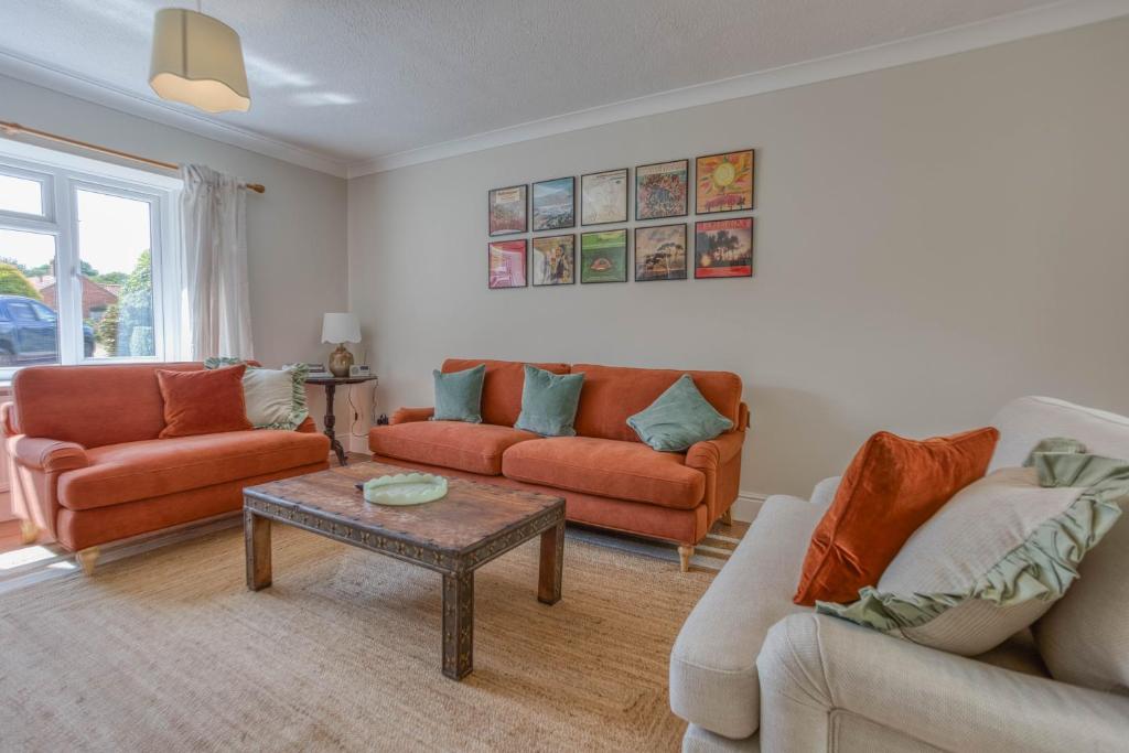 a living room with two couches and a table at Blackbird Cottage, Burnham Market Stylish & Chic - Crabpot Cottages, Hunstanton in Burnham Market