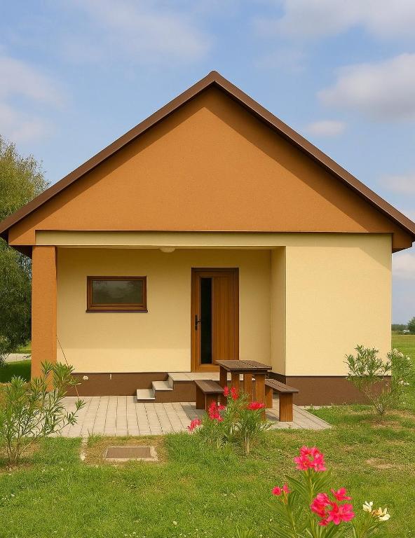 a small house with a picnic table in front of it at Domček Lodenica in Šintava