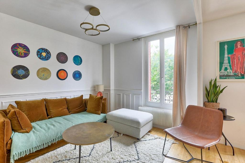 a living room with a couch and a table at Modern and Calm 2 Bedroom Appartment T3 in Paris