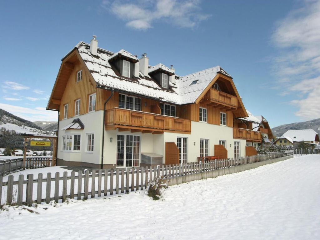 a house in the snow with a fence at Apartment St Margarethen near Ski Lift in Sankt Margarethen im Lungau