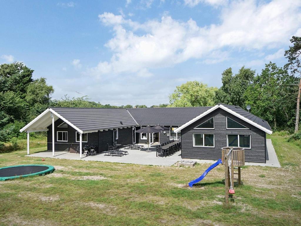 a house with a playground in front of it at 5 star holiday home in Nexø in Bedegård