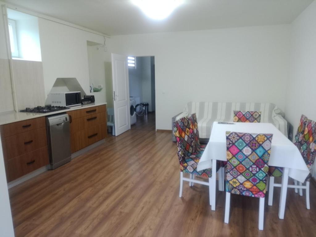 a kitchen and dining room with a table and chairs at Casa Corvinia in Hunedoara