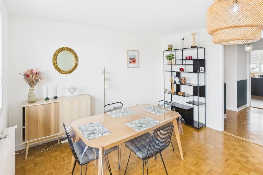 Un comedor con mesa y sillas en Savinéa, en Sainte-Savine