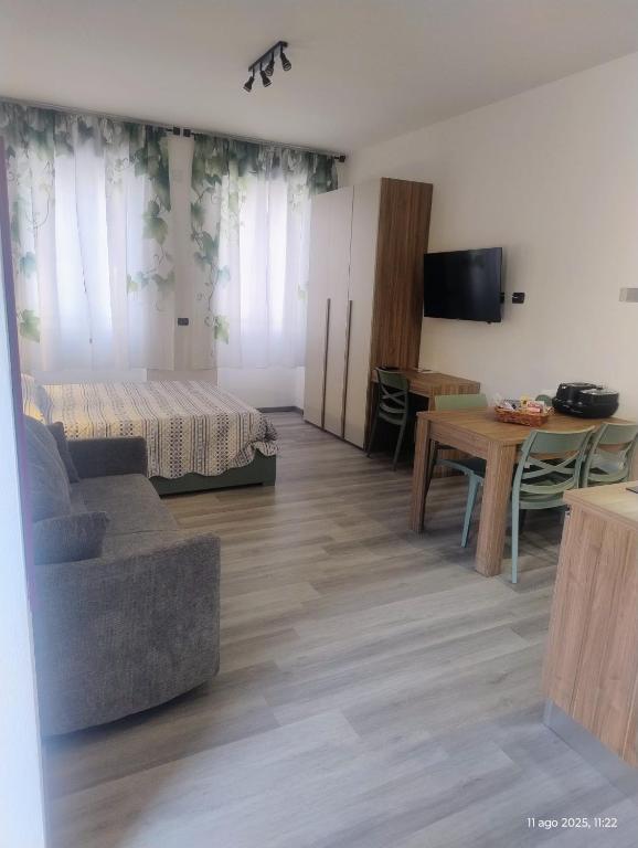 a living room with a bed and a table at Malpensa Sleep & Go in Somma Lombardo