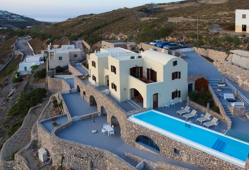 an aerial view of a villa with a swimming pool at Zatrikion Santorini Villas in Pyrgos