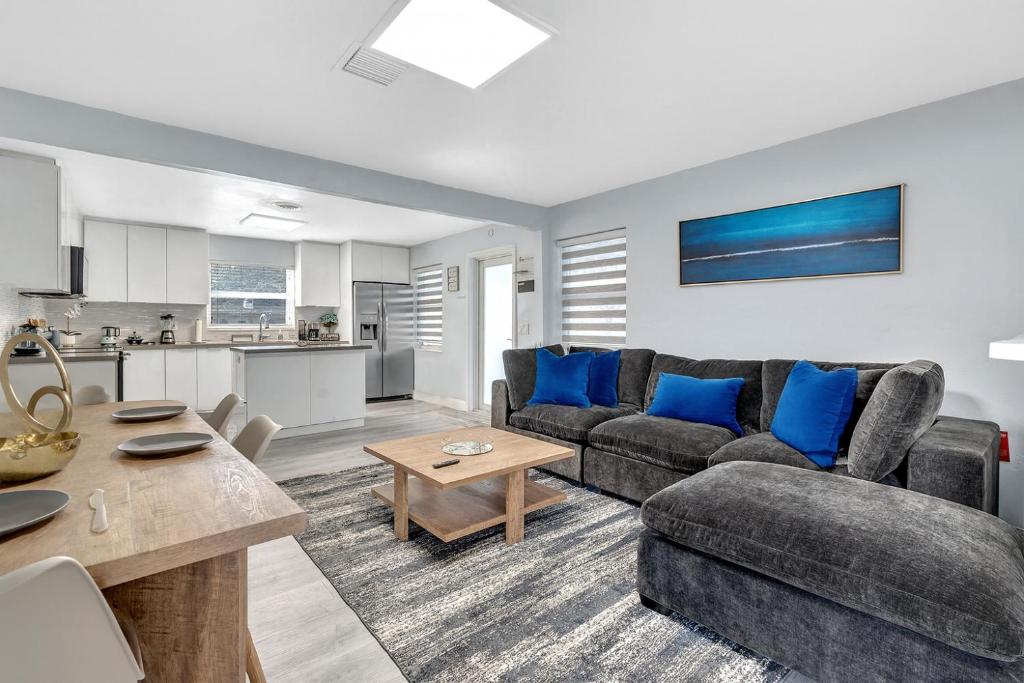 a living room with a couch and a table at 3br Villa W Fire Pit By Hard Rock Hotel & Casino in Fort Lauderdale