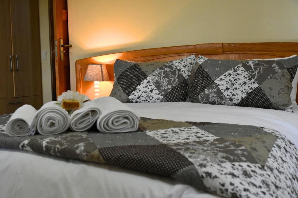 a pile of towels sitting on top of a bed at Wilderness Whispers in Wilderness