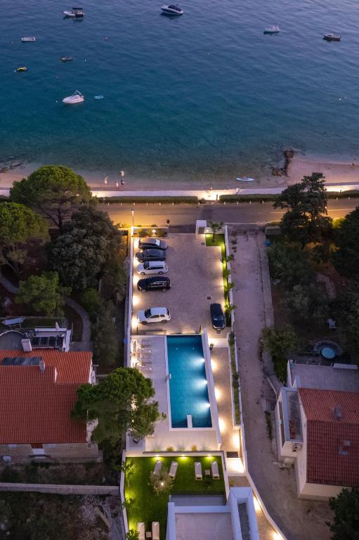 an aerial view of a beach with a pool at Bumblebee apartments & rooms with pool in Novalja