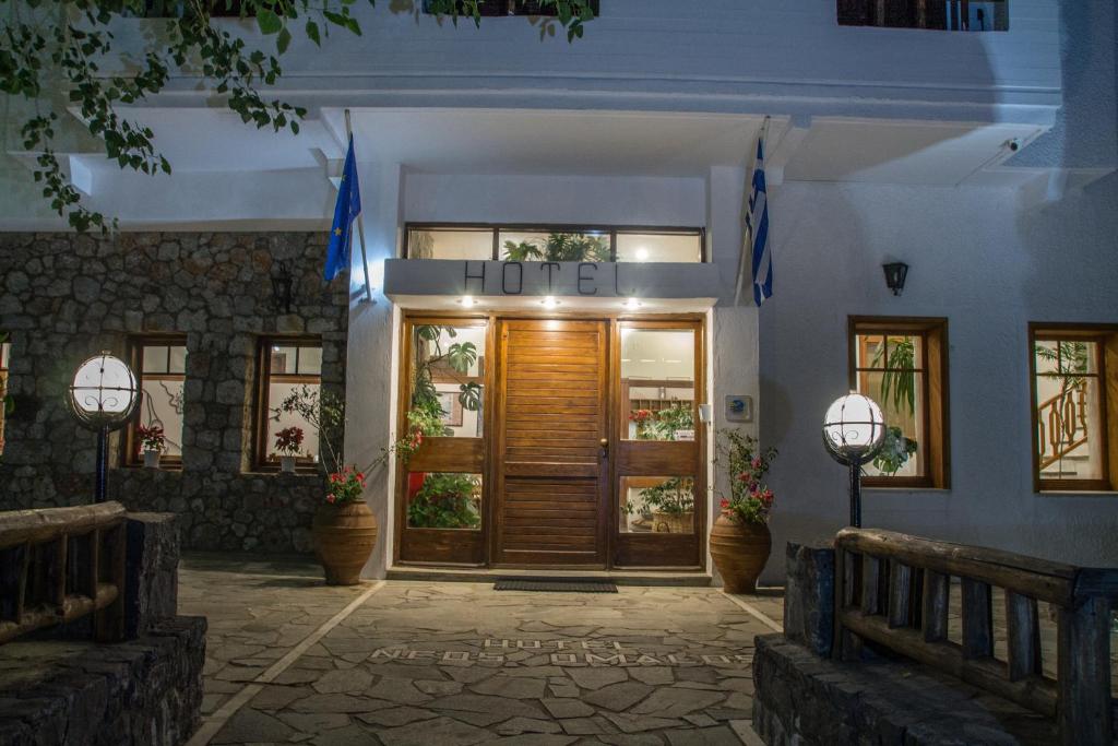 a front door of a hotel at night at Neos Omalos Hotel in Omalos