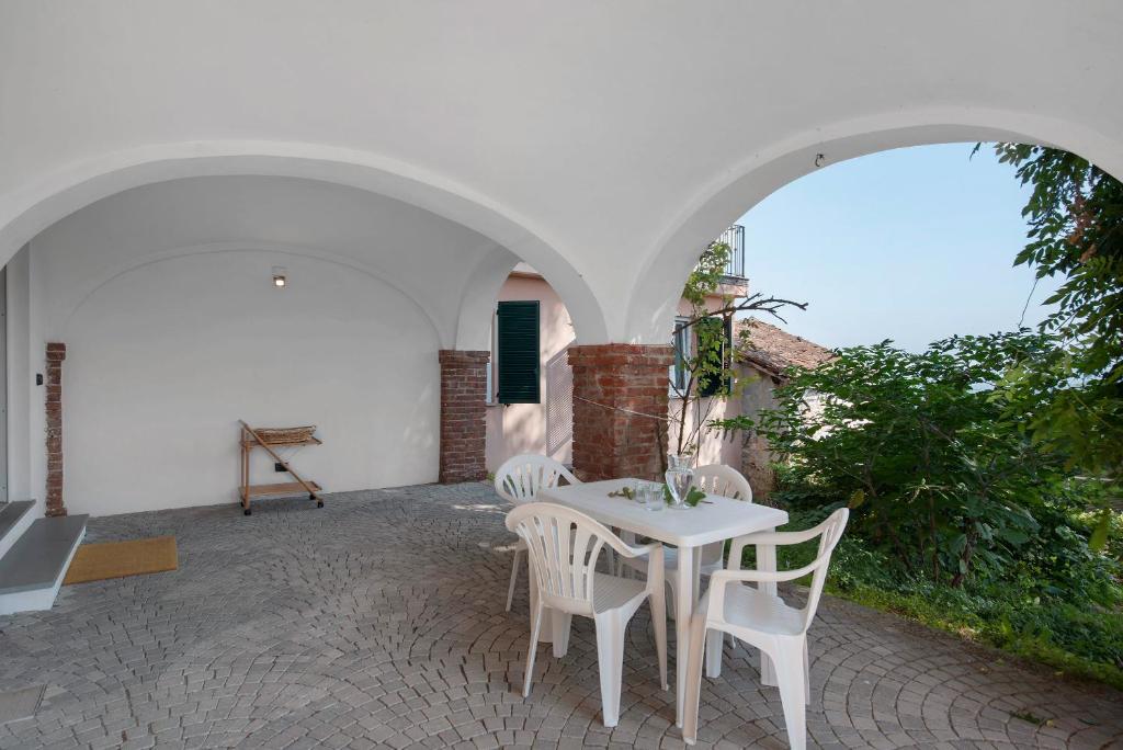 a white table and chairs on a patio at Vacanza Nel Cuore Del Monferrato in Rocca Grimalda