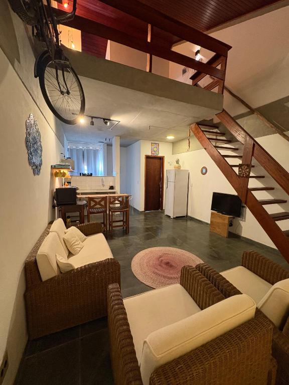 a living room with two couches and a kitchen at Loft charmoso bem no centro in São Sebastião