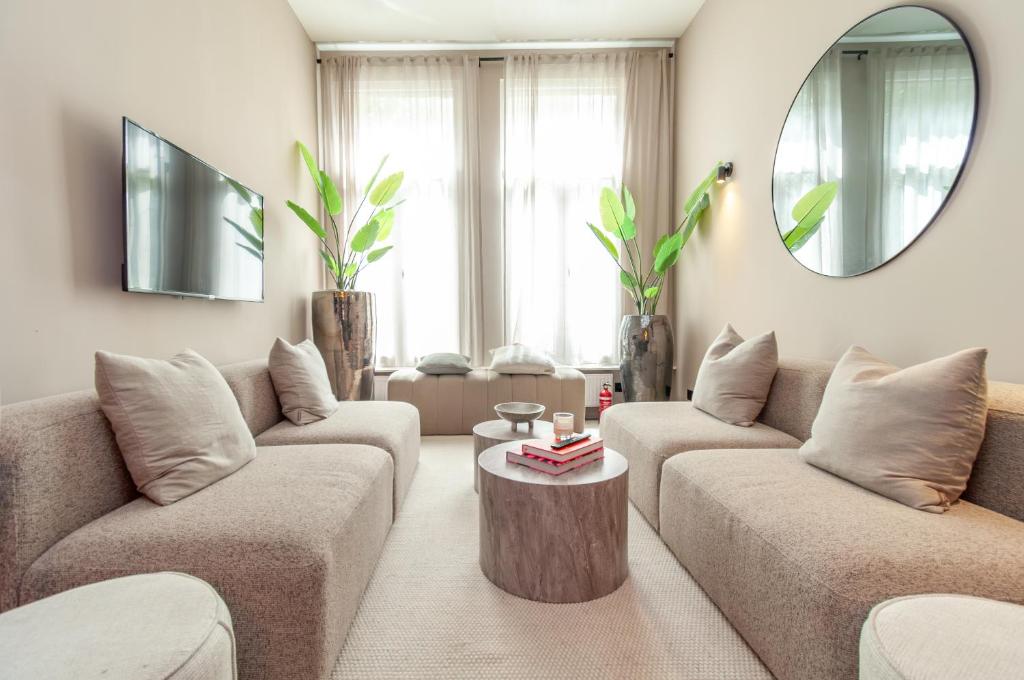 a living room with two couches and a coffee table at Holiday Home in Antwerp in Antwerp