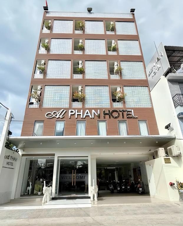 a hotel with a sign on the front of it at Alphan Hotel in Vạn Ninh