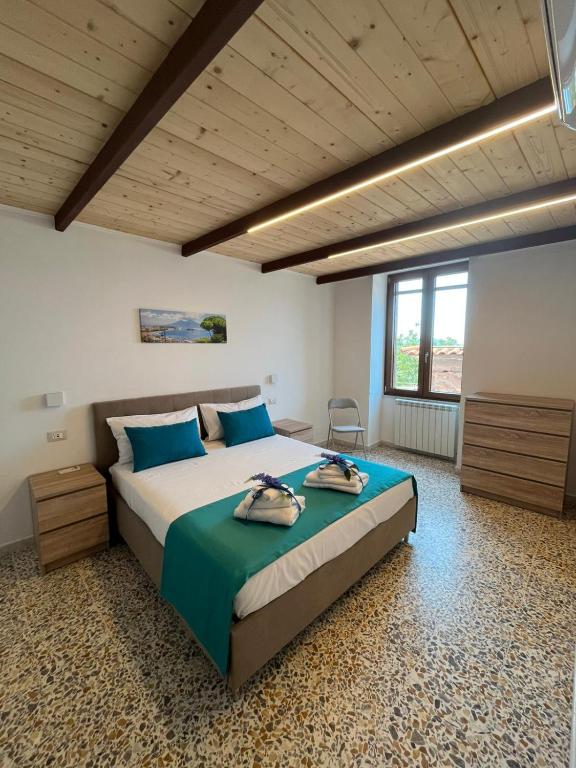 a bedroom with a large bed with blue pillows at Nello House in Vico Equense