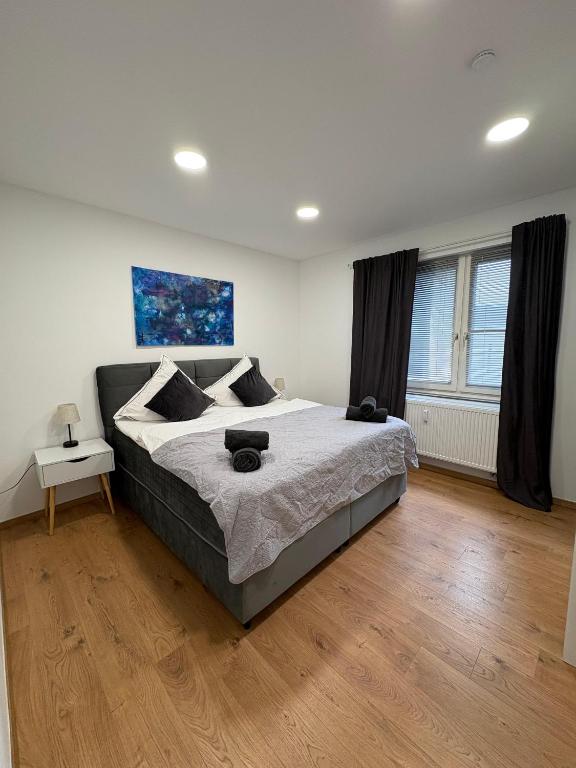 a bedroom with a large bed and a wooden floor at RUEHOME in Essen
