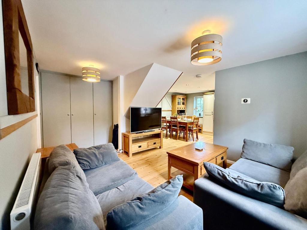 a living room with two couches and a television at 2Bed Cottage Near Odiham Castle Scenic Field Views in Greywell