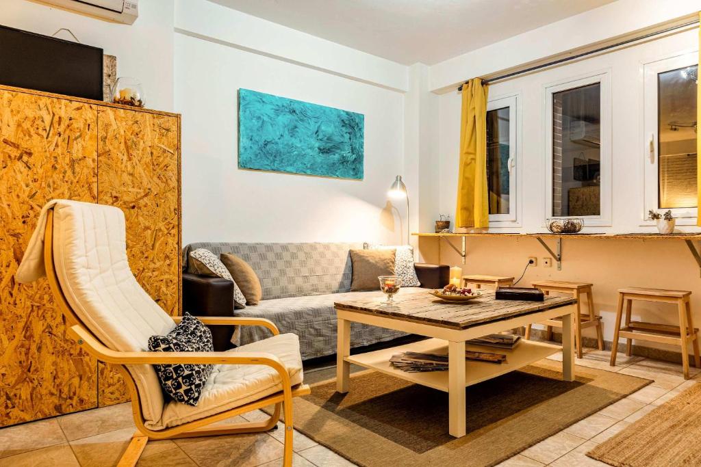 a living room with a table and a couch at Downtown Central Suite with Private Parking in Kalamata