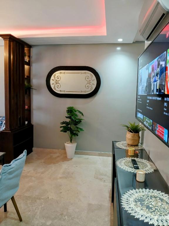 a living room with a desk and a tv at Beachside Apartment in Mohammedia