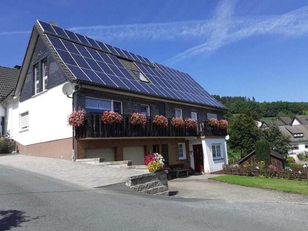 a house with solar panels on top of it at Gemütliche Wohnung für 4 Personen in Medebach