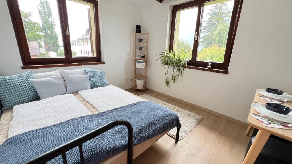 a bedroom with a bed and two windows at SusaLie in Mauren