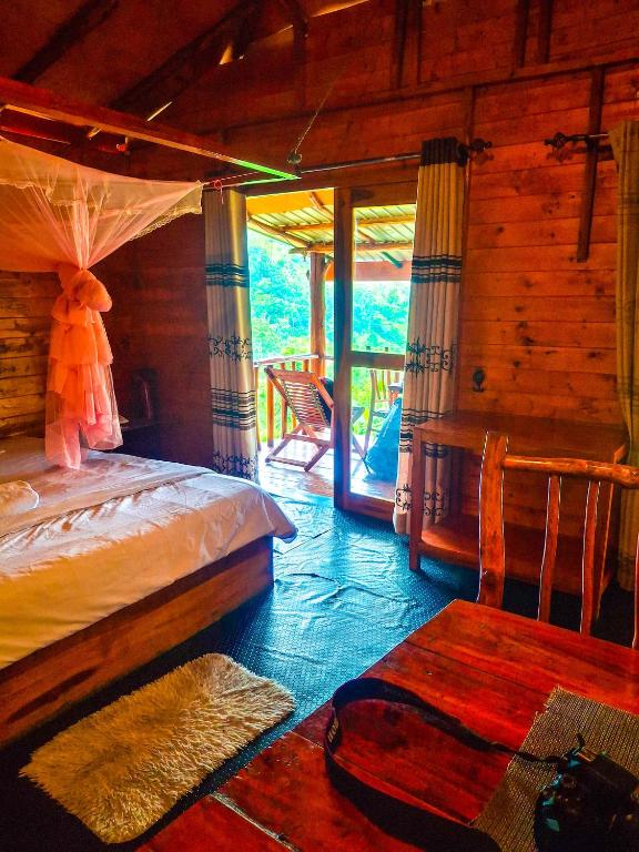 a bedroom with a bed in a log cabin at Bamboo Cabana Ella by Hill crest in Ella