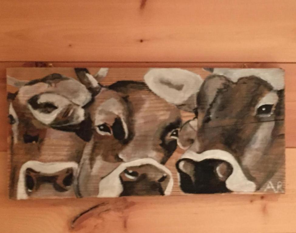 a painting of a group of cows on a wall at Chalet Gipfelblick Inzell in Inzell