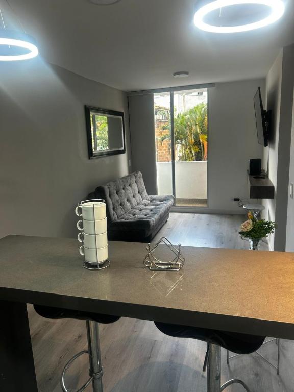 a living room with a couch and a table at Aptosvacacionales Medellín in Medellín
