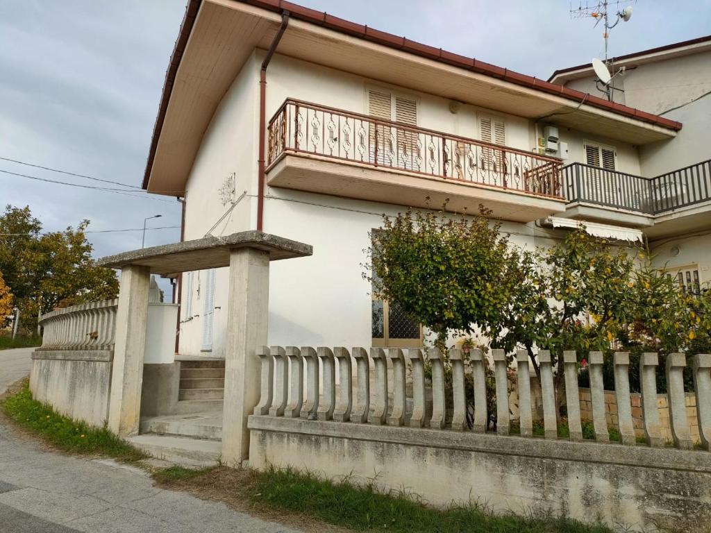 a white house with a fence in front of it at casa delle colline in Torano Nuovo