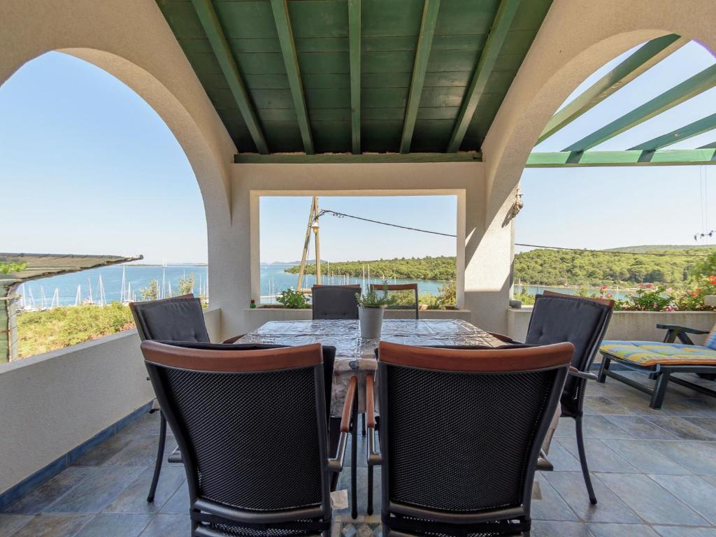 an outdoor dining room with a table and chairs at Holiday Home in Veli Rat near Saharun in Veli Rat