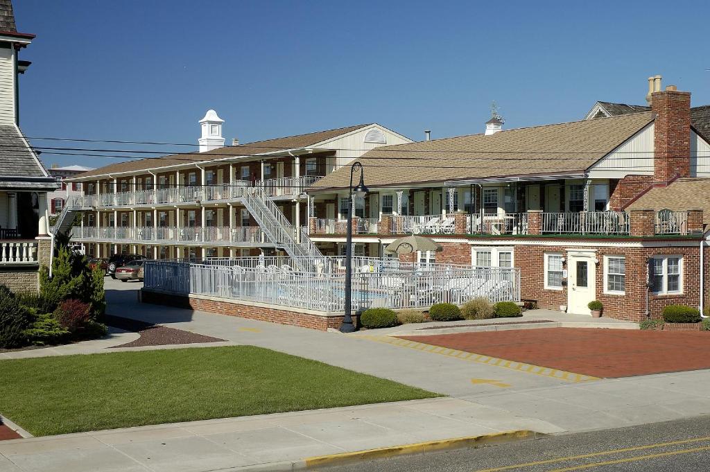 a large brick building with a staircase in front of it at Stockton Inns in Cape May