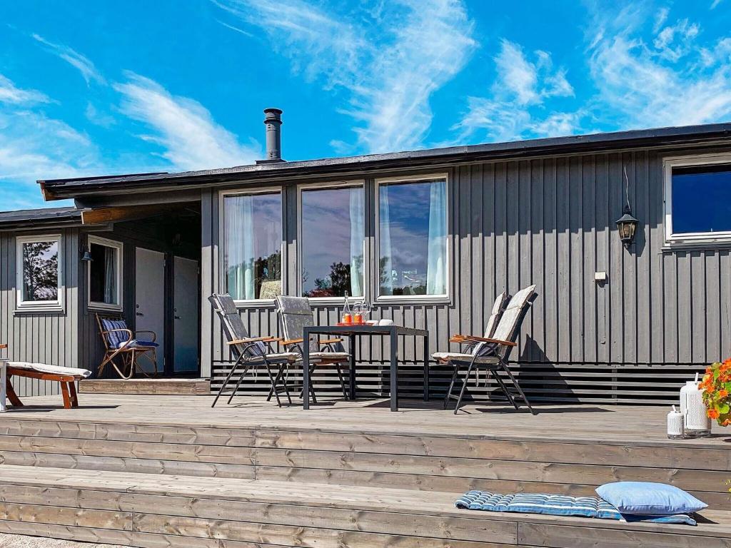 a patio with chairs and a table on a house at 9 person holiday home in Vesterøy in Hauge