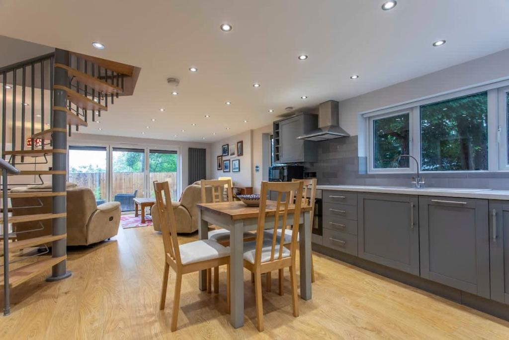 a kitchen and dining room with a table and chairs at Abbey Rectory - with private parking in Bath