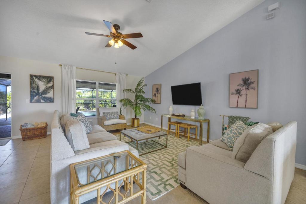 a living room with two couches and a ceiling fan at Family Retreat - Sleeps 10 - Pool - Near Beach in Port Charlotte