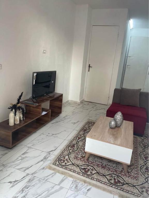 a living room with a couch and a tv at House of la Marsa in Dar Tahar Zaouch