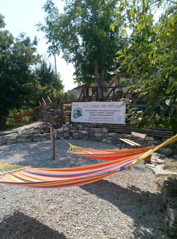 a hammock in front of a sign in a park at Bed And Breakfasts LA CASETTA in Terranova di Pollino