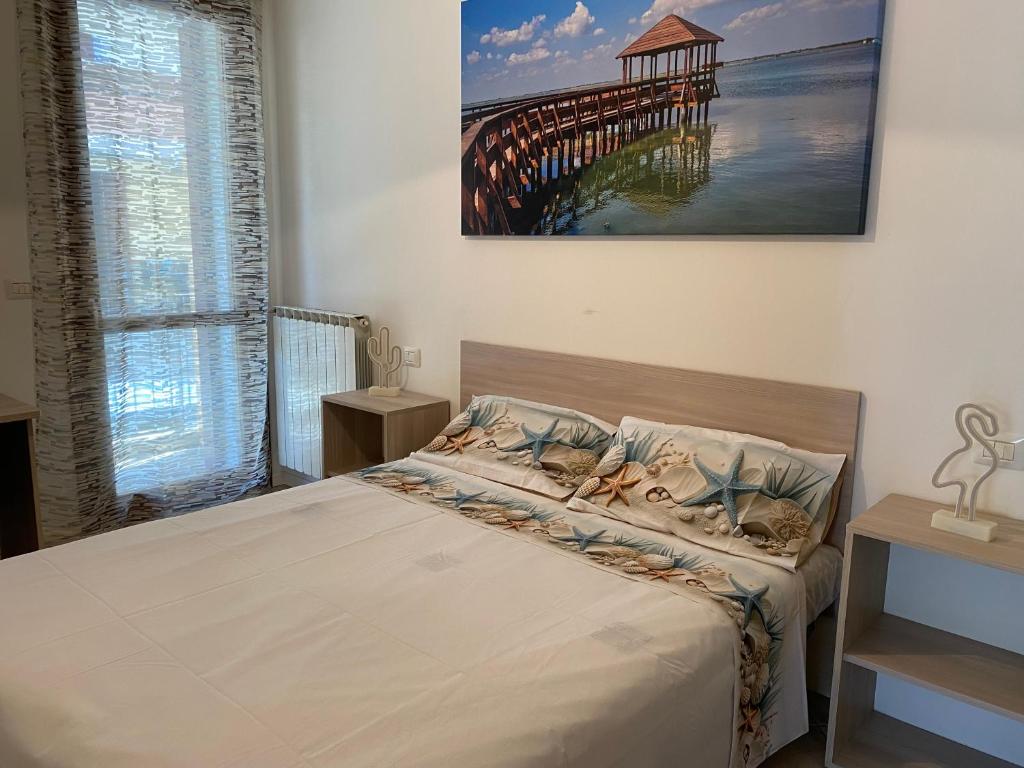 a bedroom with a bed and a pier at A casa di Giulia in Rosolina