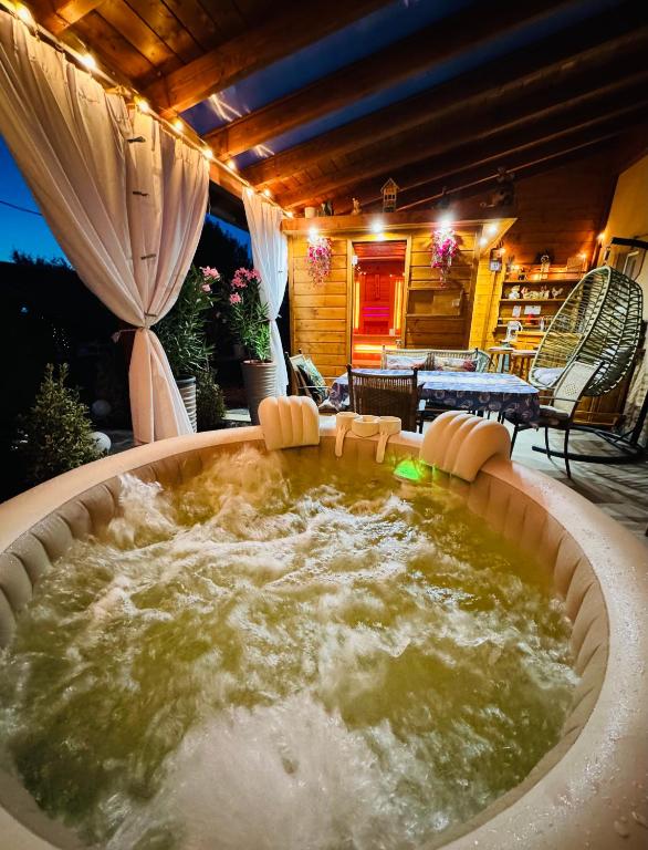 a large tub of water in a yard with a patio at Arany Vendégház in Szarvas