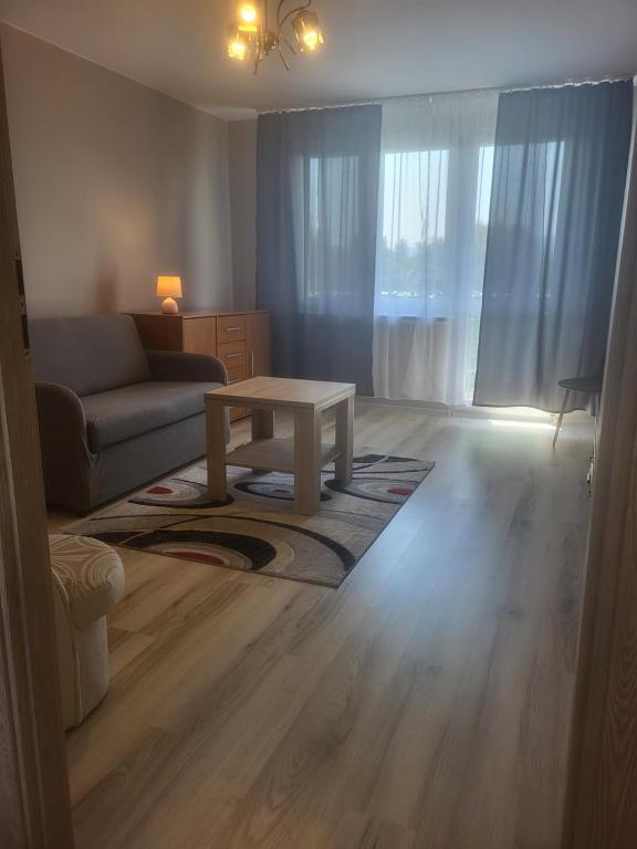 a living room with a couch and a coffee table at Panorama in Dzierżoniów