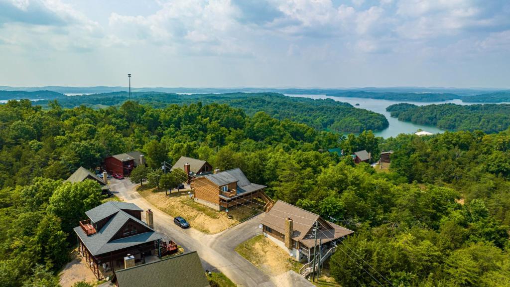 an aerial view of a house in the woods with a river at Panoramic Peak by American Patriot Getaways in Walnut Grove
