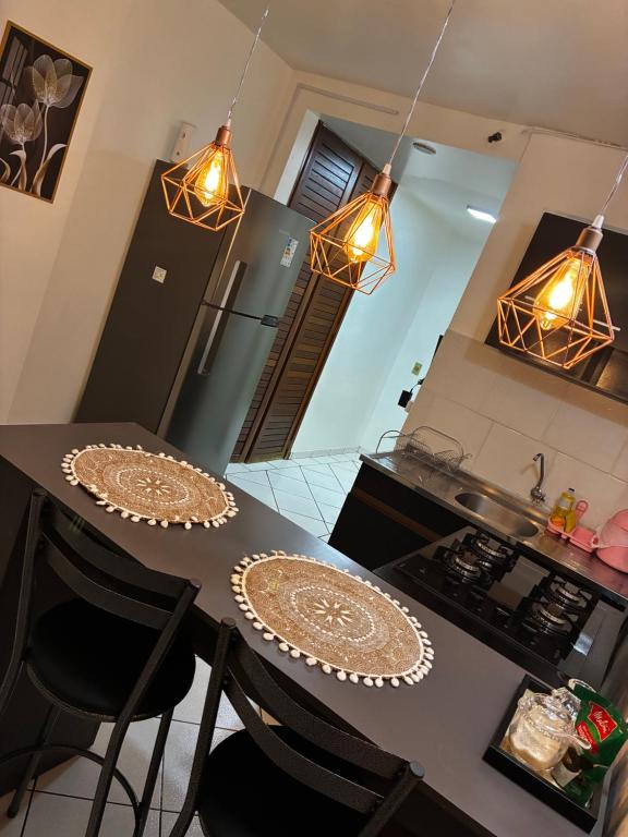 a kitchen with a table with two plates on it at Flat Aconchegante in Goiânia
