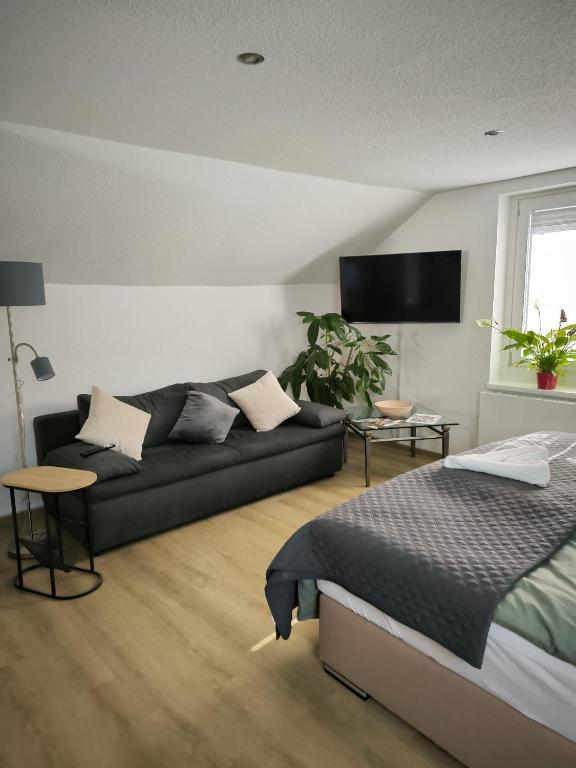 a living room with a couch and a bed at Ferienwohnung Am Sonnenbrink in Goslar