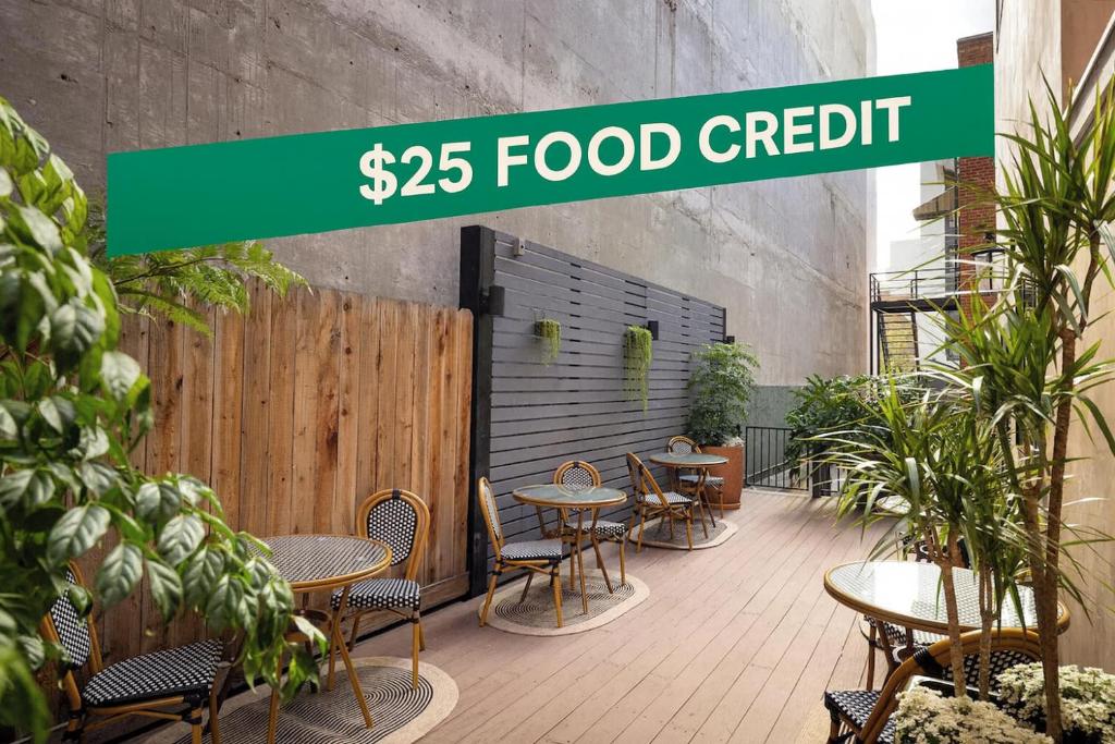 a restaurant with tables and chairs and a sign that reads food credit at The Beau Hotel Downtown San Diego Gaslamp Quarter in San Diego