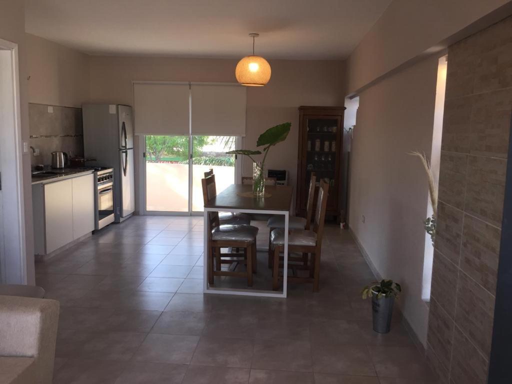 a kitchen and dining room with a table and chairs at Departamento in Alta Gracia