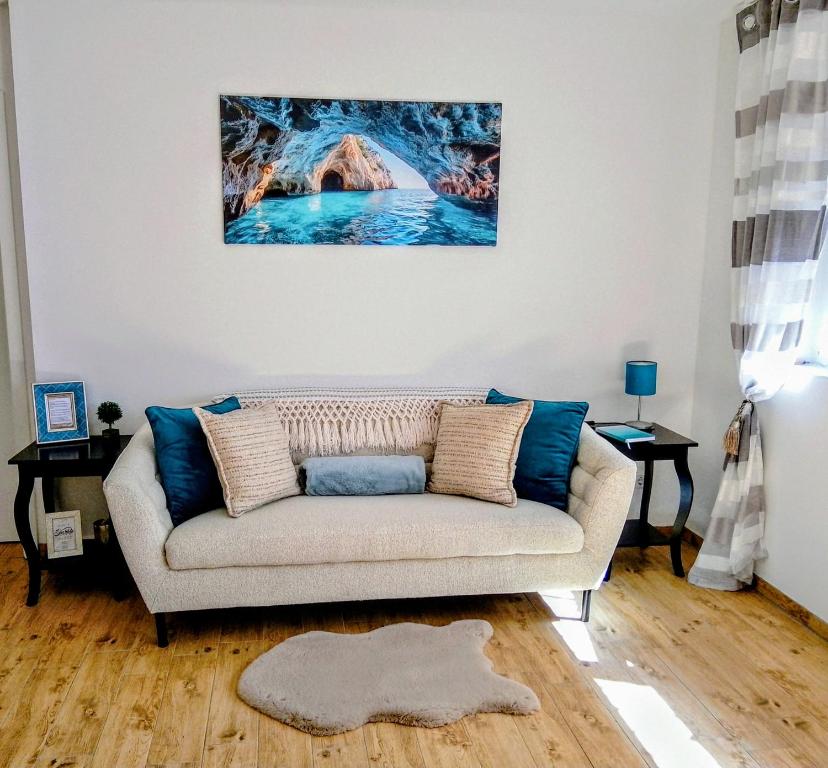 a living room with a couch and a painting on the wall at Harmony Private Single Room Freiburg in Freiburg im Breisgau