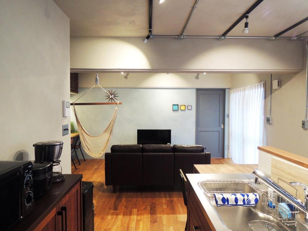 a kitchen and living room with a couch and a table at I will meet Nesabu, - Vacation STAY 33801v in Tomigusuku
